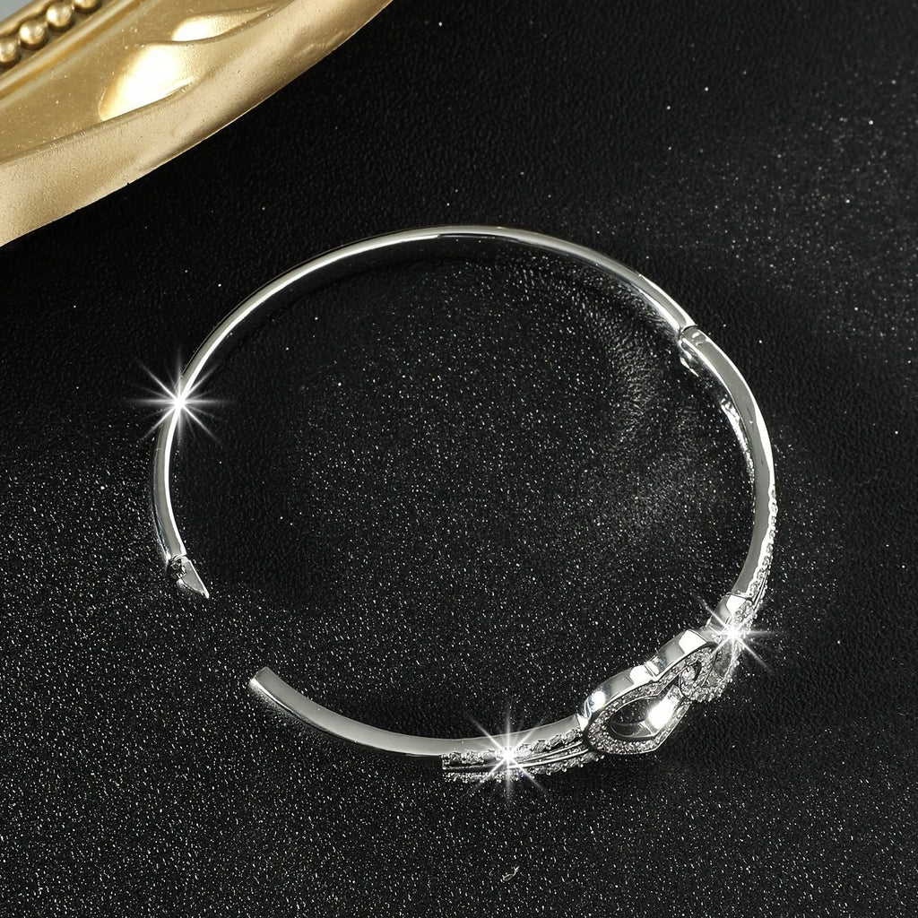 Silver bracelet with decorative elements on a black background