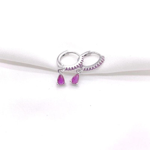 Pair of silver hoop earrings with purple teardrop gemstones on a white background