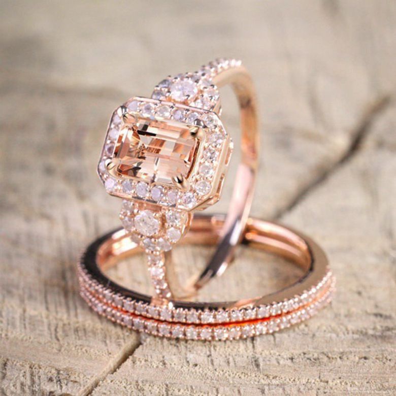 Rose gold ring with a large diamond on a textured surface